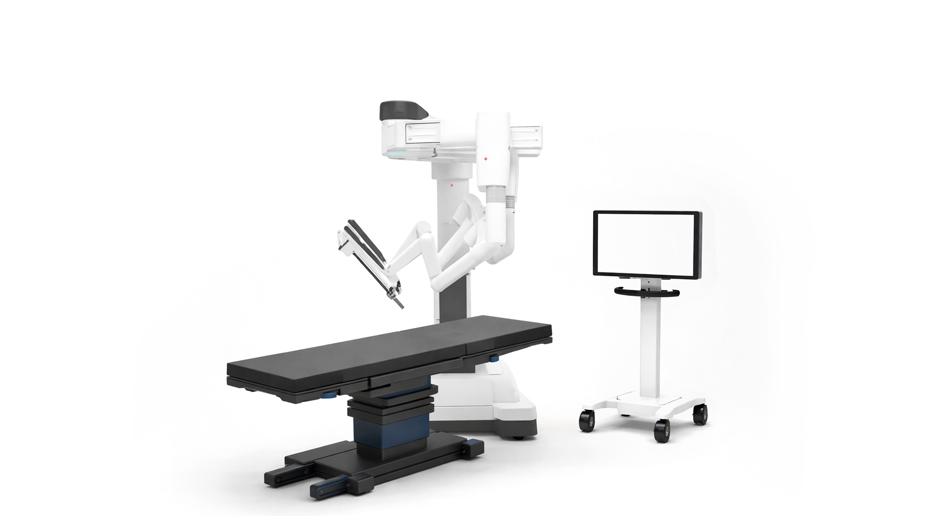 Surgical table, robotic-assisted surgical device, and custom medical display found in a surgical suite.