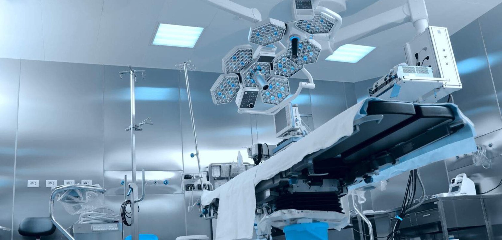 Surgical suite highlighting the surgical table, lights, and medical devices.