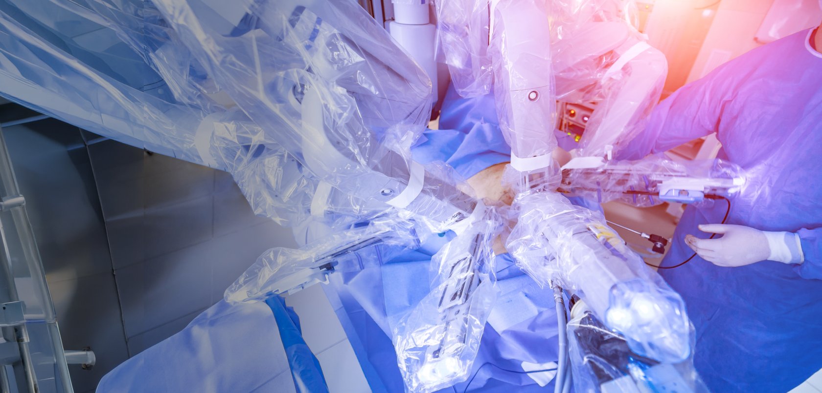 A surgeon performs a procedure with a robot-assisted surgical device.