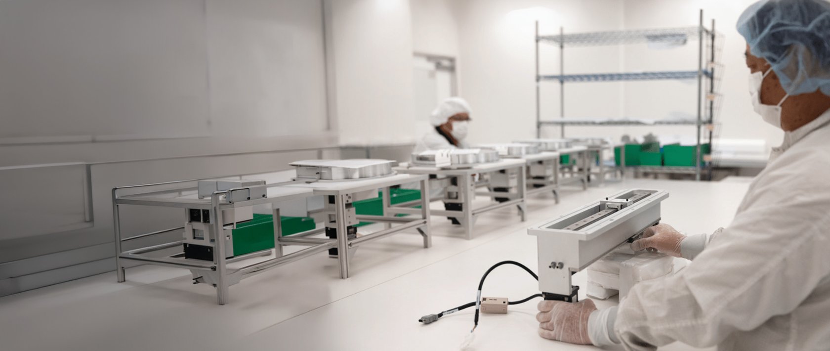employee working in manufacturing facility for metrology with inspection equipment