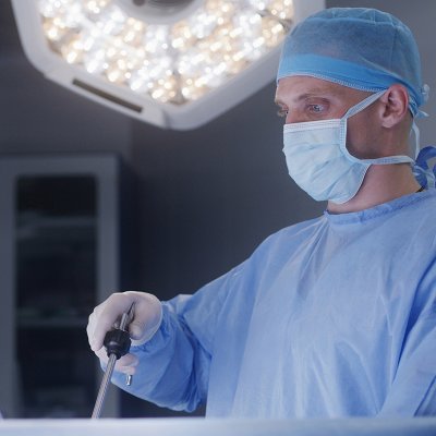 Male surgeon in operating room with surgical light