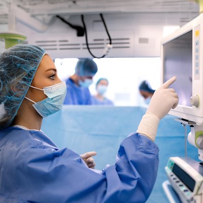 Female surgical technician using medical display