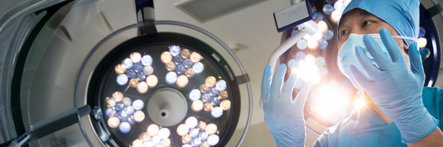 Surgeon in operating room with surgical light