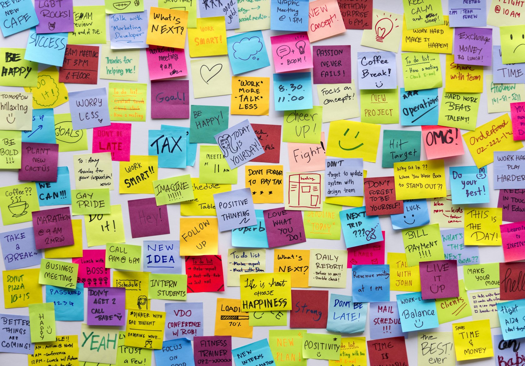 Mental Health Awareness Month notes of encouragement on sticky notes on wall